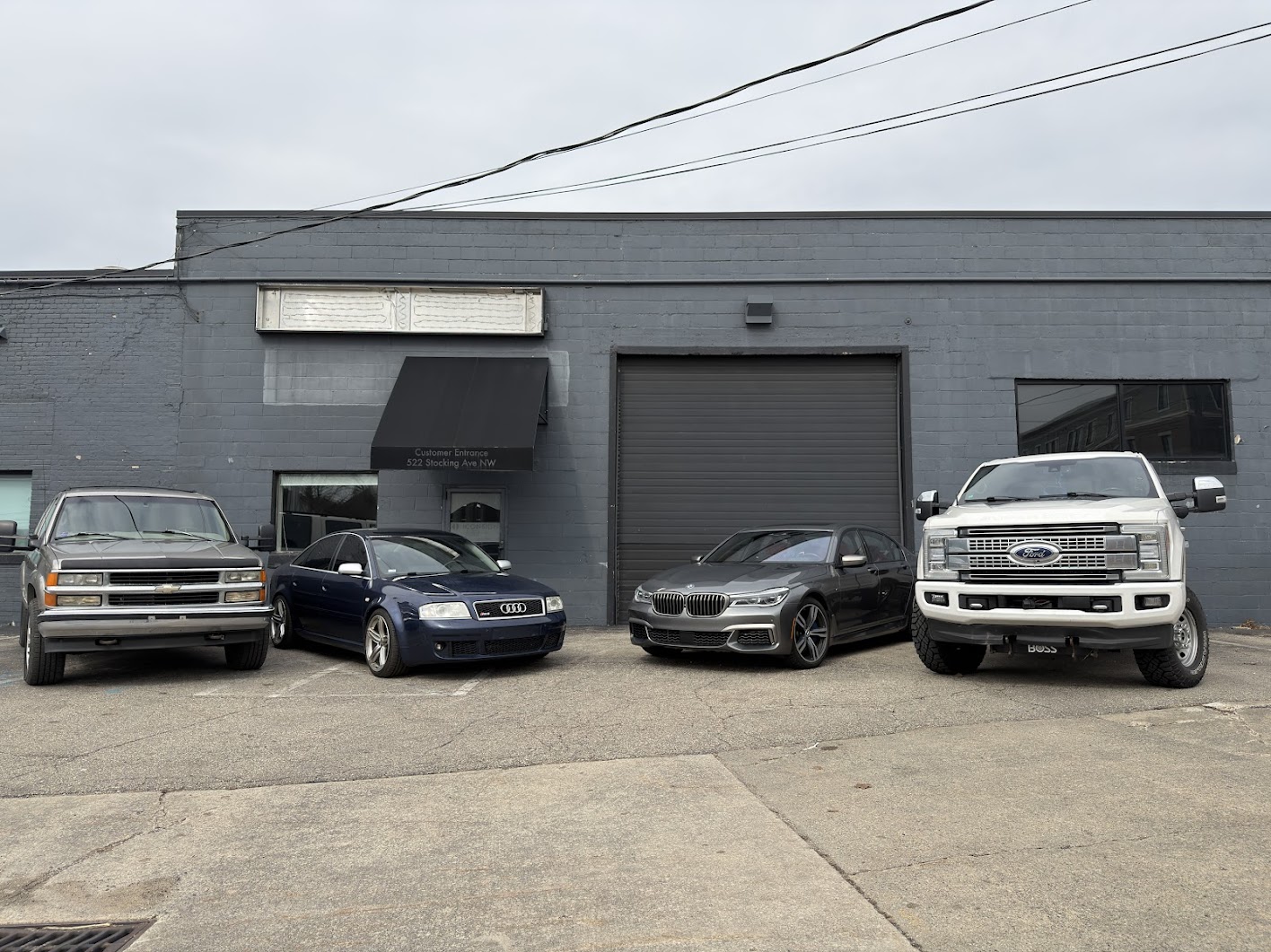 Wrench Club facility — four daily drivers lined up at 522 Stocking Ave NW